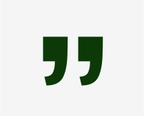 A green and white image of two quotation marks.